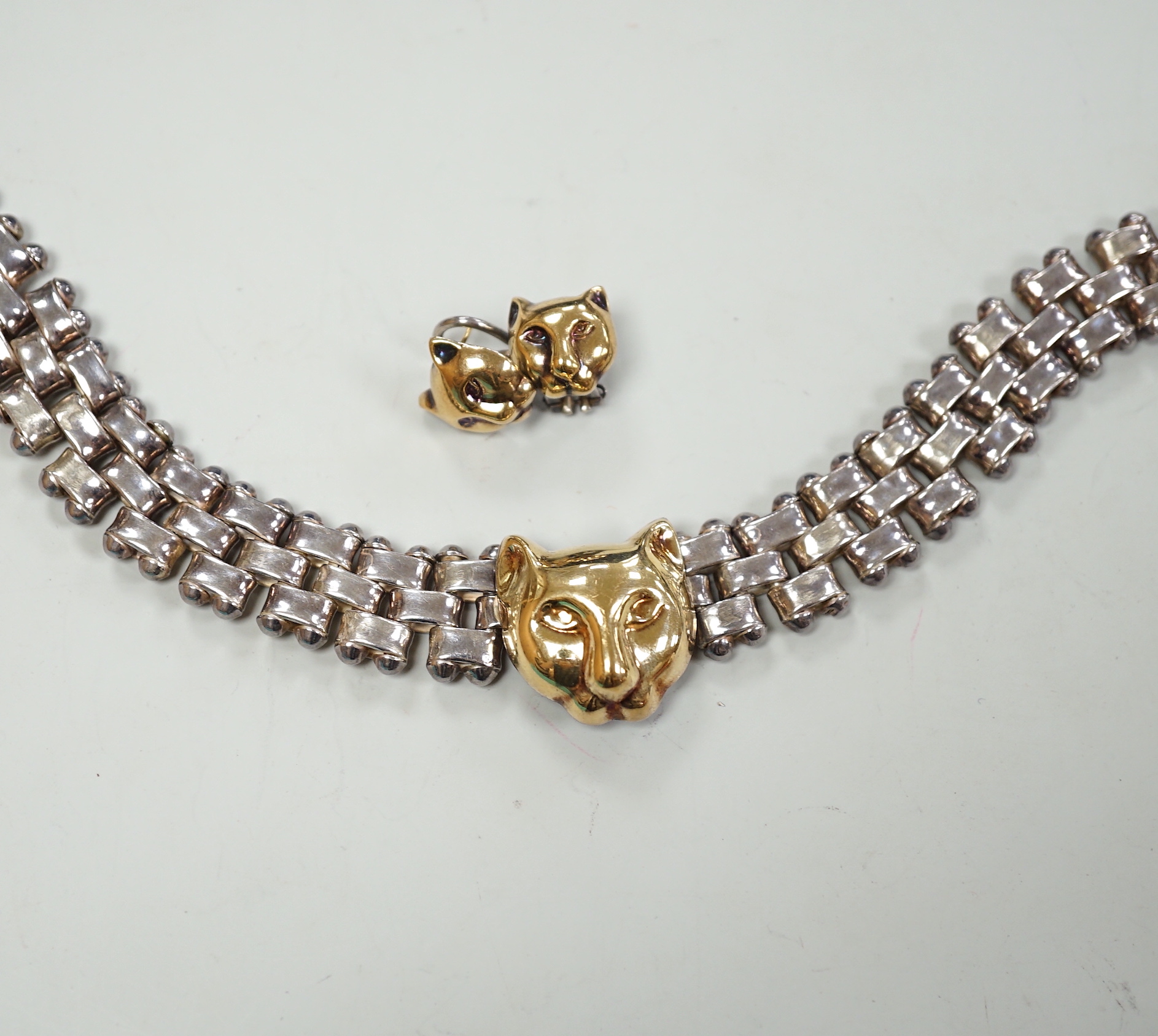 A modern Italian silver and 750 yellow metal necklace and pair of matching earrings, with leopard's head motif, necklace, 40cm.